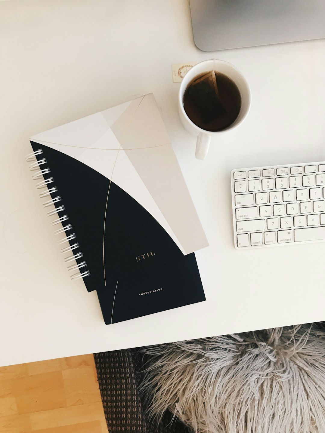 Open notebook, mug, and keyboard on a tidy desk.